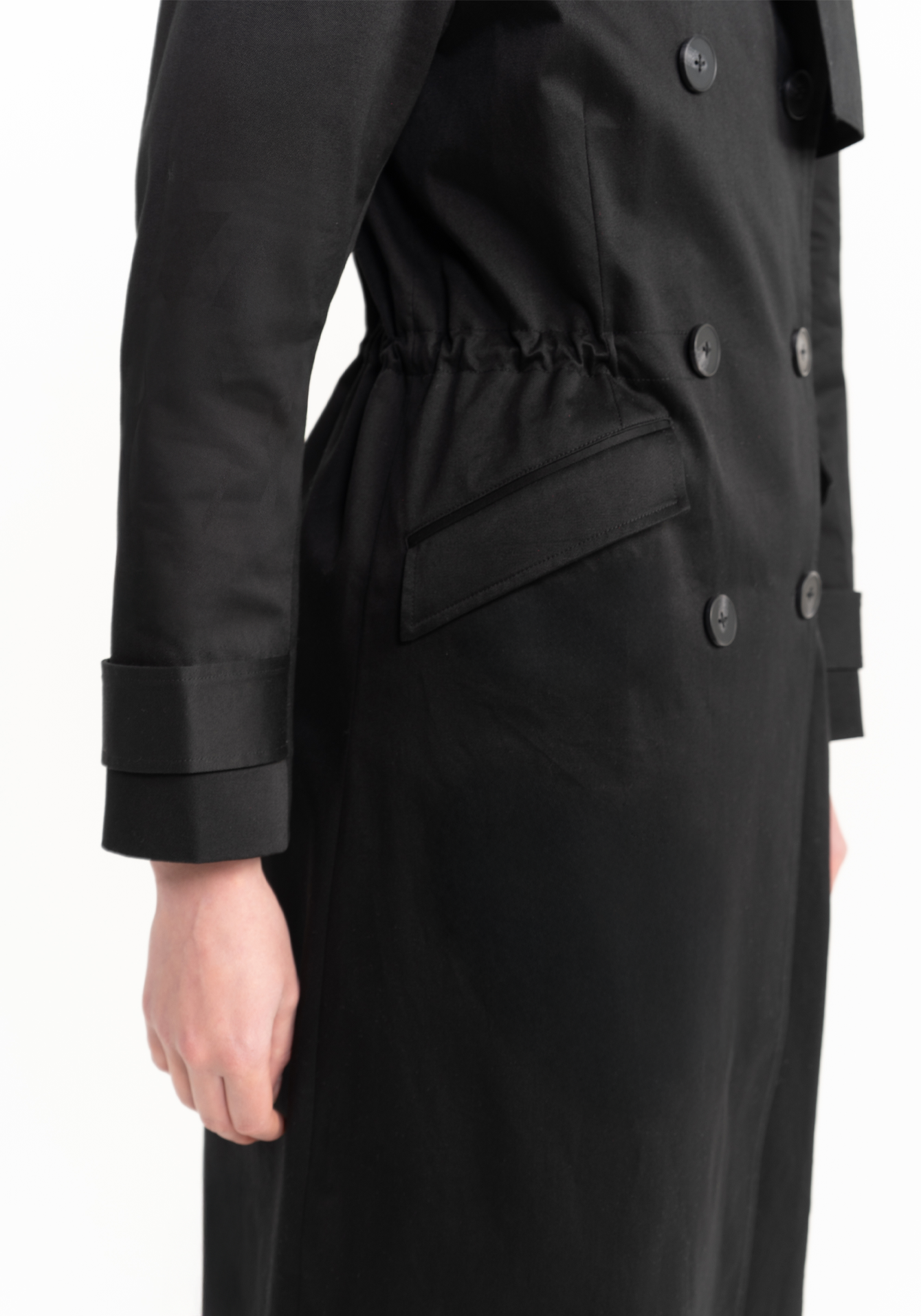 Black trench coat with a belt on a white background - pockets