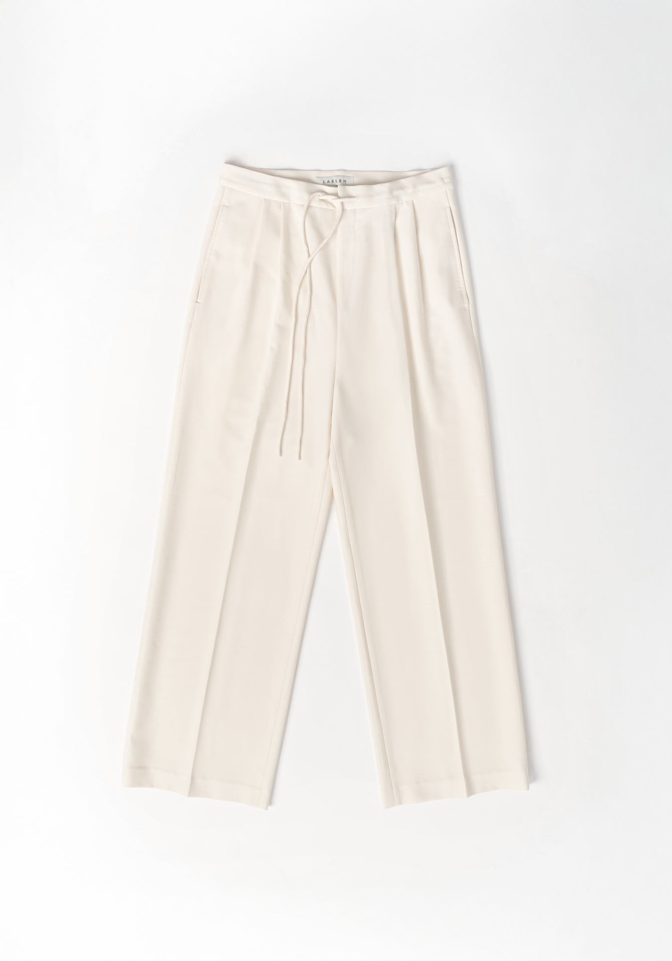 Cream trousers on a white background - flatlay