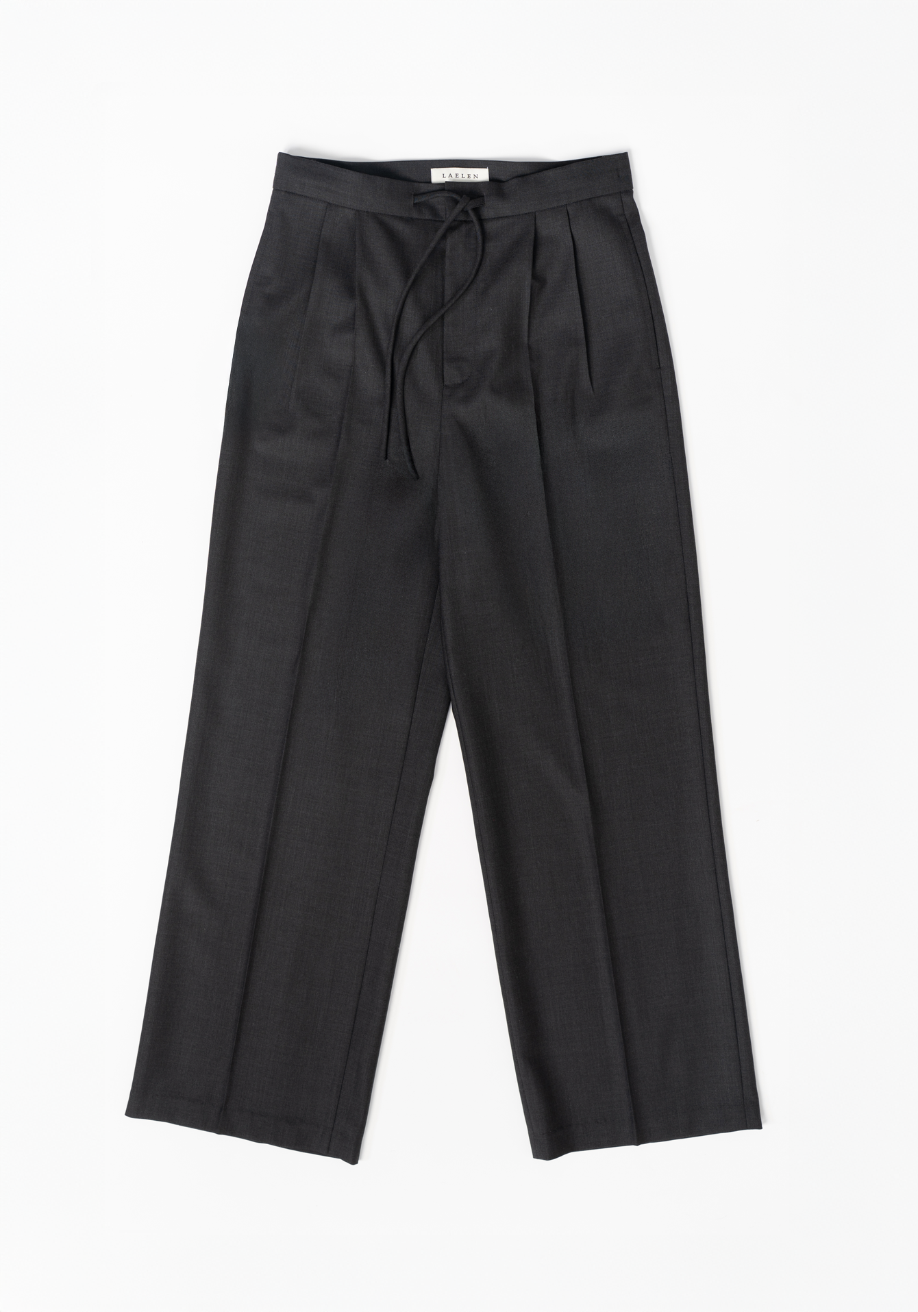 Dark grey trousers with a tie waist on a white background - flat lay