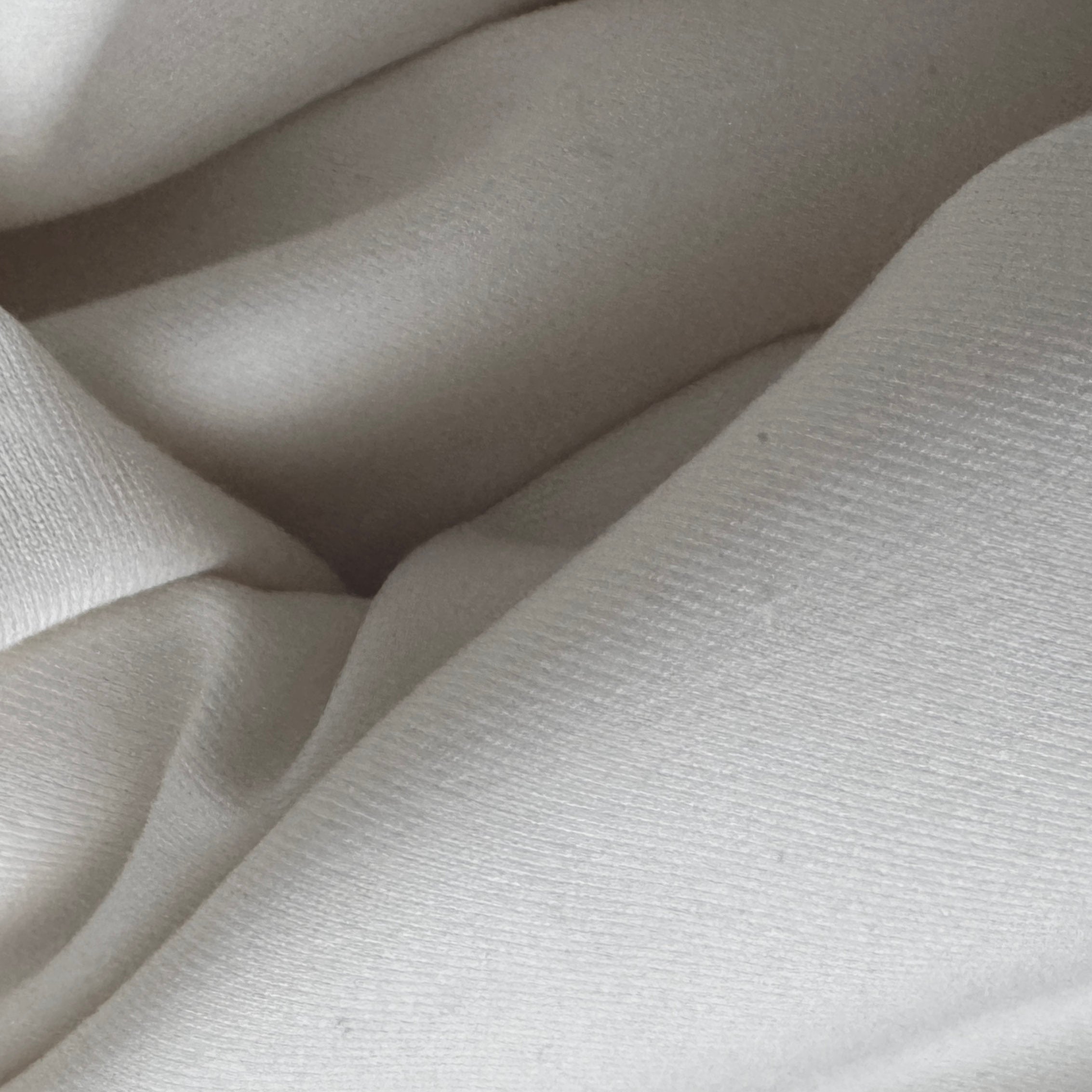 Close-up of light gray fabric with visible texture